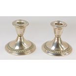 A pair of Gorham silver dwarf candlesticks, each with fluted border and base, stamped Gorham Sterlin