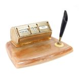 A 1950s onyx desk stand, with applied brass coloured desk calendar, with day, date and month, with p