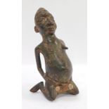 Tribal Art. A seated bronze figure of a female, cast, 22cm high.