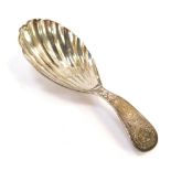 A George III silver caddy spoon, with a fluted bowl, handle with bright cut engraving, reserve monog