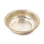 An Egyptian bowl, engraved with Arabesques and script, within an acanthus leaf border, white metal,