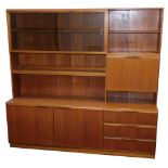 A mid century teak wall unit, with sliding two shelved bookshelf top section, with open bookcase, co