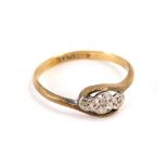 A 9ct gold and platinum twist ring, the twist central section with three illusion set tiny diamonds,