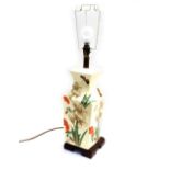 An Oriental ceramic table lamp, with painted detailing of red and white flowers, with butterflies an