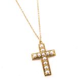 A crucifix pendant and chain, the crucifix set with seed pearls in yellow metal, unmarked, 3cm high,