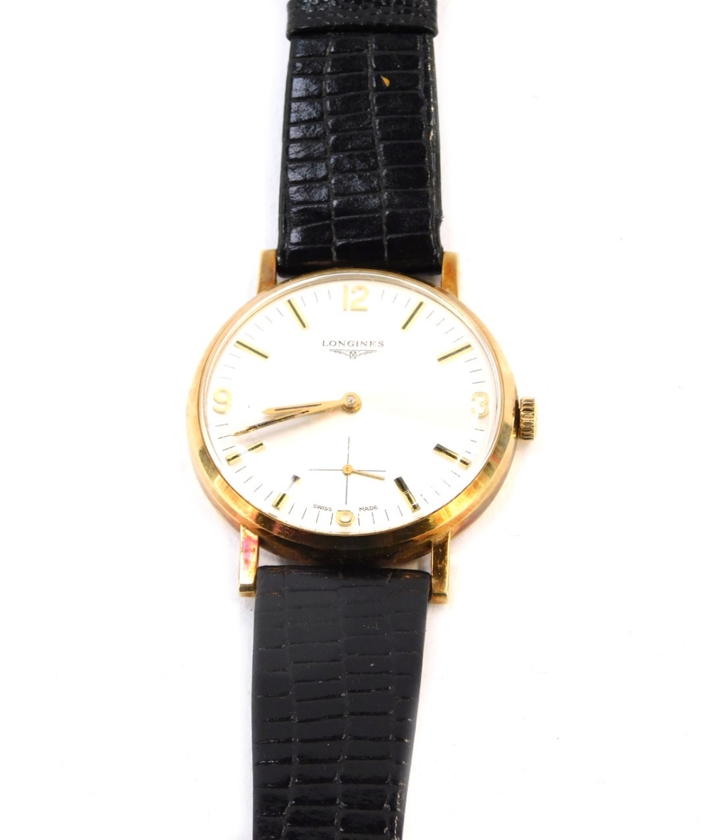 A Longines 9ct gold gent's wristwatch, with a silver coloured dial, with four point number section a