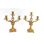 A pair of 19thC gilt metal rococo candelabra, each with three branches cast with leaves, 35cm high,