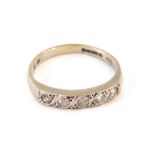 A 9ct white gold diamond half hoop dress ring, set with five round brilliant cut tiny diamonds, on a