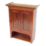 A mahogany wall hanging cupboard, with moulded cornice and two single doors with single shelf base