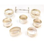 A Victorian silver knife rest, Chester 1901, five silver napkin rings, including one engraved with c