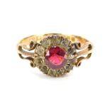 A 9ct gold dress ring, the cluster set with central red paste stone surrounded by white paste stone