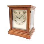 An early 20thC mahogany cased mantel clock, with silver coloured Roman numeric dial, twenty one day