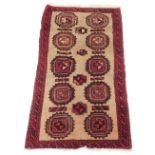 A Persian Belouch type rug, with a design of two rows and five medallions in red, on a cream ground