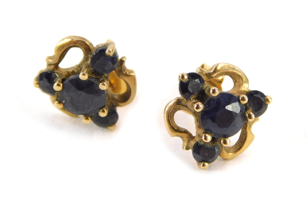 A pair of 9ct gold stud earrings, each formed as a cluster set with sapphires, 1.5g all in.