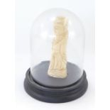 A 19thC Chinese ivory figure of a male figure with a staff, 11cm high, in a modern glass dome.