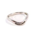 A diamond and platinum dress ring, the twist design band set with seven tiny diamonds, stamped PT, r
