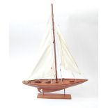 A wooden pond yacht, with two material masts.