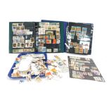 Two albums containing various world stamps, Canadian stamps, American and Olympic stamps, etc., and