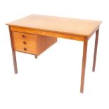 A 1960's/1970's teak desk, with three drawer arrangement, on tapered legs, 72cm high, 103cm wide, 60