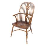 A 19thC oak and elm Windsor chair, with a vase shaped splat, turned spindles, solid saddle seat, rai