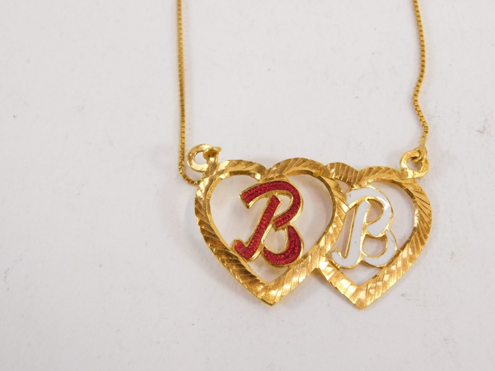 An enamel and yellow metal pendant and chain, the two adjoining heart pendant bearing the initials B - Image 2 of 3