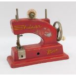 A Vulcan Minor miniature sewing machine, in red, 14cm high.