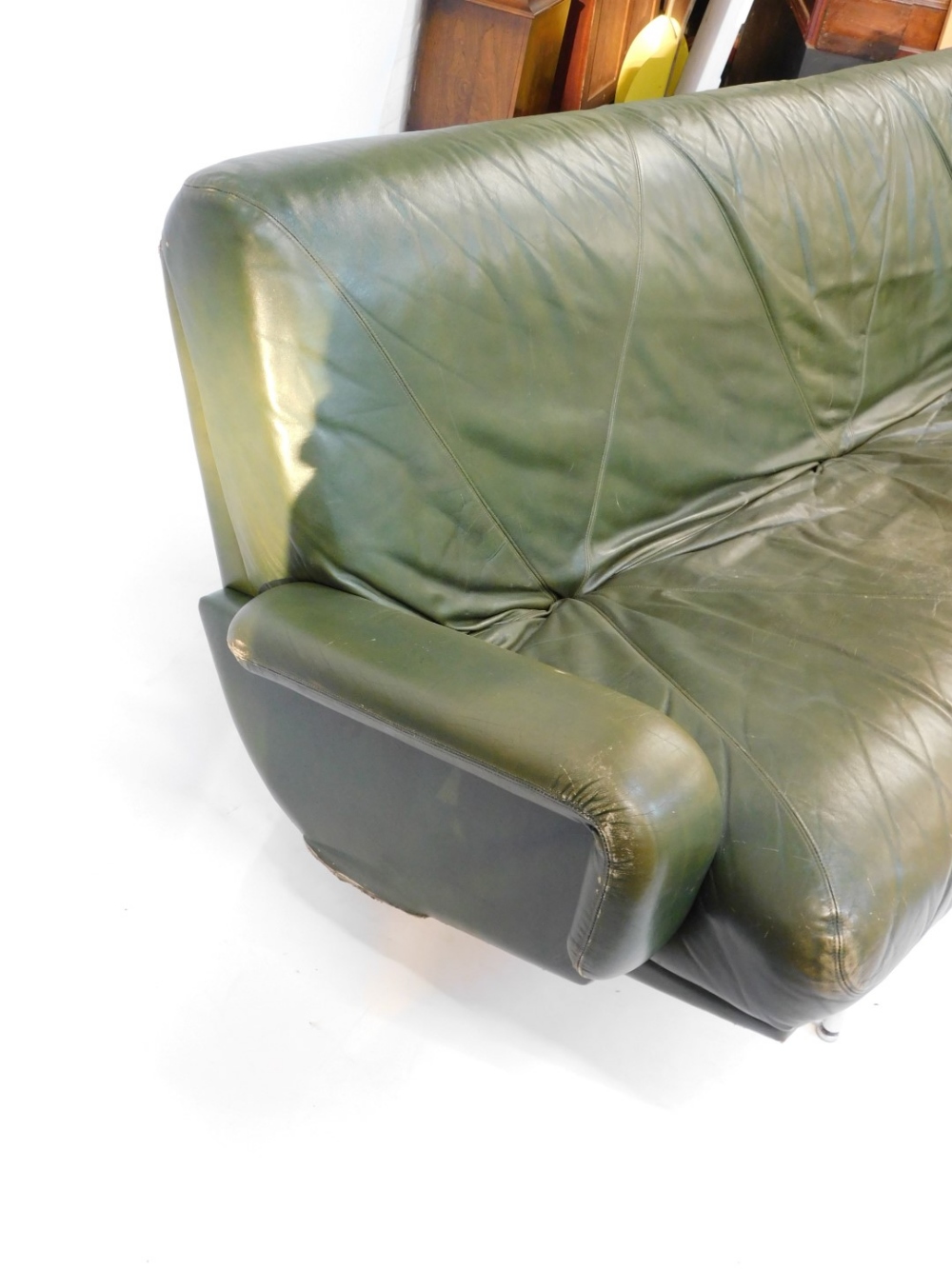 A 1960's vintage green leather three seater sofa, raised on twin chrome plated and cast iron support - Image 3 of 4