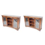 A pair of Old Charm oak cabinets, with two astragal glazed doors and central bookshelf section, on b