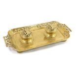 A late 19thC French brass inkwell, the rectangular tray with scroll leaf design, with two hinged bra