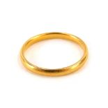 A 22ct gold wedding band, of plain design, misshapen, ring size L½, 2.7g.