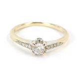 A diamond set dress ring, the round brilliant cut in a four claw setting, approx 0.20cts, with four