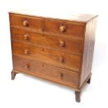 A George III oak chest of two short over three long graduated drawers, raised on outswept feet, 103c