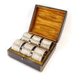 A cased set of six silver plated napkin rings.