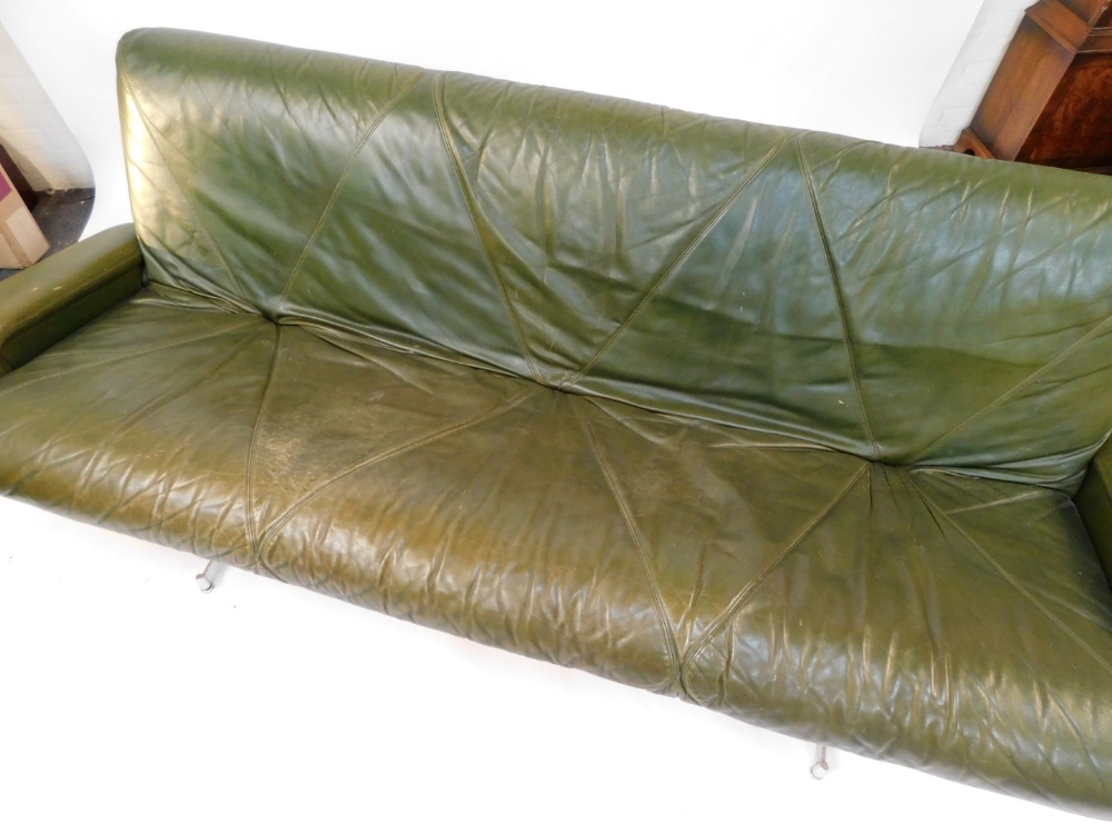 A 1960's vintage green leather three seater sofa, raised on twin chrome plated and cast iron support - Image 4 of 4