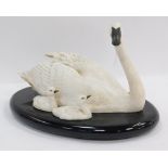 A Franklin Mint Under Her Wing swan figure group, on a black cloth oval base, 32cm diameter.