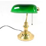 A brass desk lamp, with shaped green glass shade, 33cm high.
