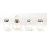 Three Victorian cut glass toilet jars, with silver lids, having engine turned decoration, circular c