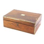 A 19thC rosewood writing box, with brass bound supports and central plaque, with a partially fitted