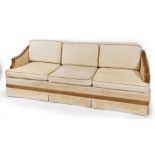 An Art Deco pollard oak framed three seater sofa, with cream upholstery, possibly American, 80cm hig