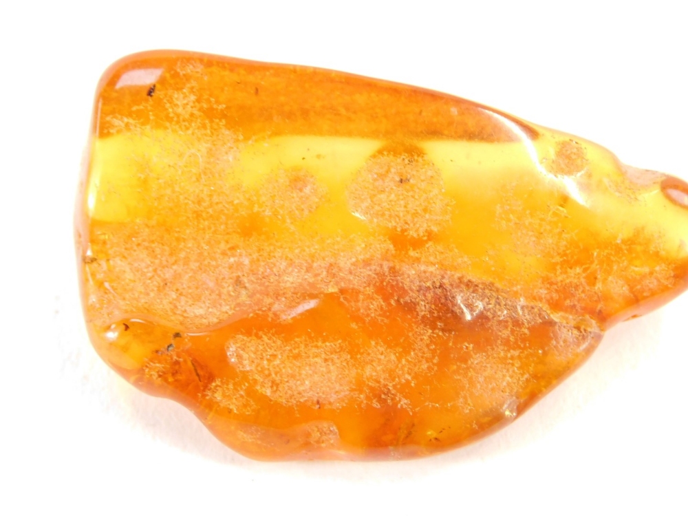 A piece of natural amber, with various growth specks and rubbed detailing, 5cm wide, 12.4g all in. - Image 2 of 3