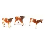 Three various Beswick and other calves, comprising one Royal Doulton brown and cream glazed calf, a