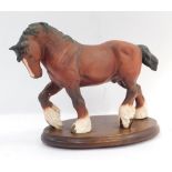 A Beswick shire horse ornament, on later oval wooden plinth, 23cm high.
