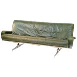 A 1960's vintage green leather three seater sofa, raised on twin chrome plated and cast iron support