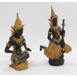 A pair of Thai inspired metal figures, depicting figures playing musical instruments, with gilt high