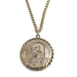 A hammered pewter pendant and chain, the pendant with figure of a lady with fan, bearing the inscrip
