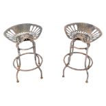 A pair of Pan and Botany swivel metal tractor seat bar stools, 65cm high, seats 47cm wide.