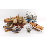 A group of ship models, comprising two wooden speedboats and various painted and wooden fishing boat