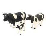 A set of three Fresian Beswick cows, each with matt glaze finish, comprising bull, cow and calf.