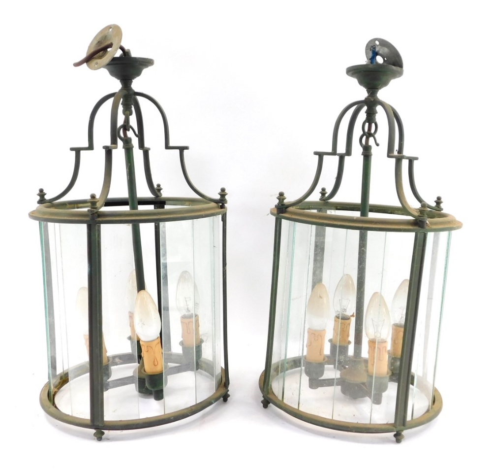 A pair of brass hanging lanterns, each cylinder form, with four fittings and various glass panels, e