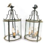 A pair of brass hanging lanterns, each cylinder form, with four fittings and various glass panels, e